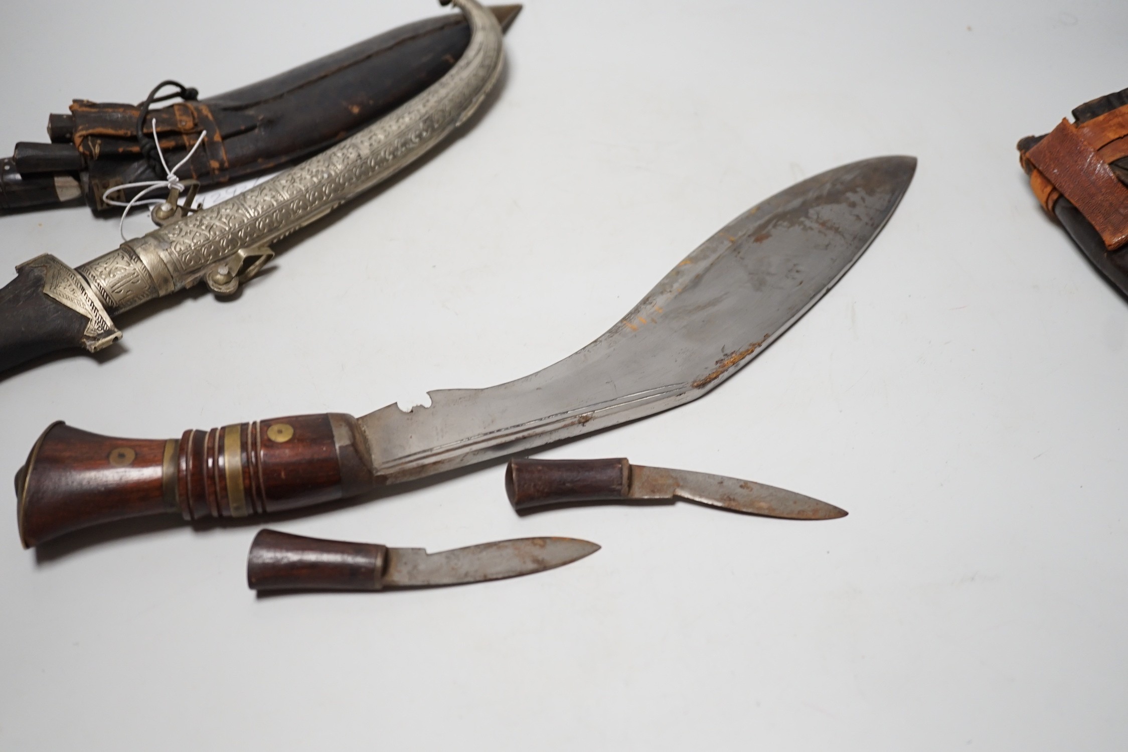 Two Kukri and eastern daggers, within engraved sheath, (3)